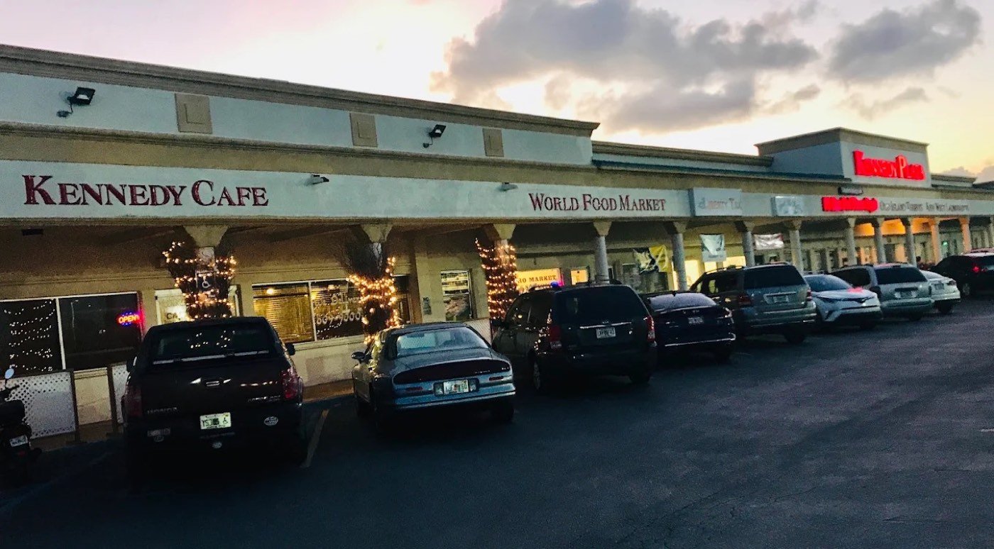 Kennedy Cafe storefront at Key Plaza at dusk