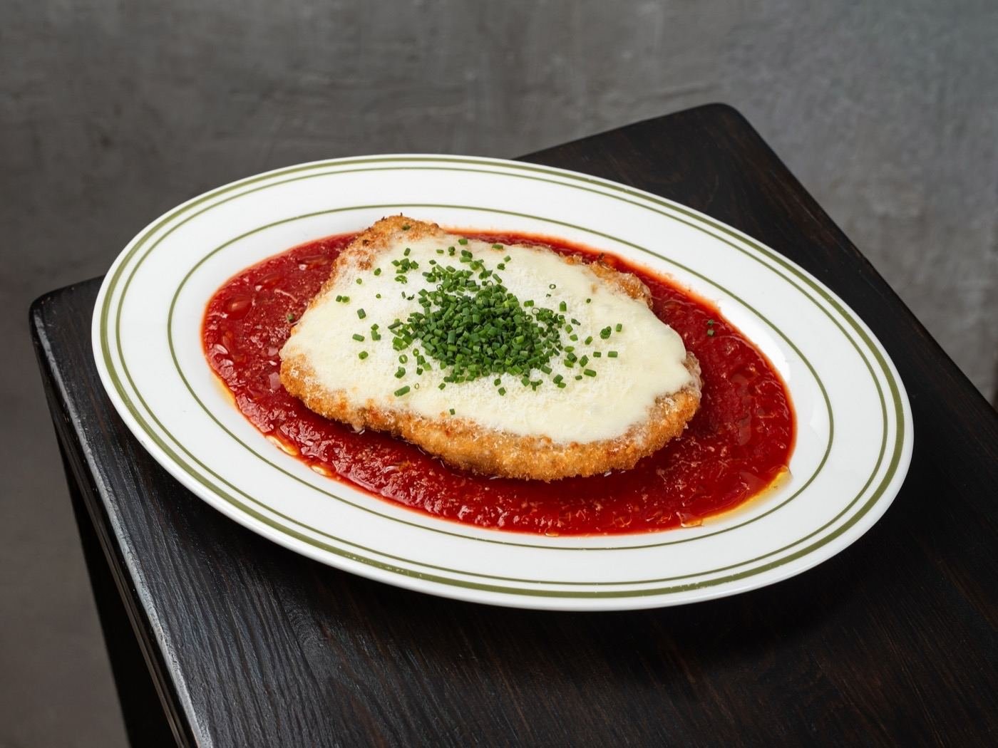 Chicken Parmesan dinner over spaghetti